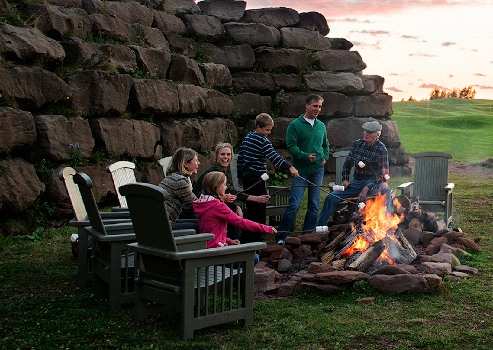 Guests gathered around a bonfire at Fox Harb'r Resort